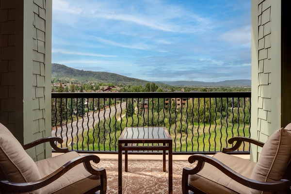 Your private balcony offers sweeping mountain vistas—unwind in comfort as you take in the peaceful hillside and valley views stretching into the distance.