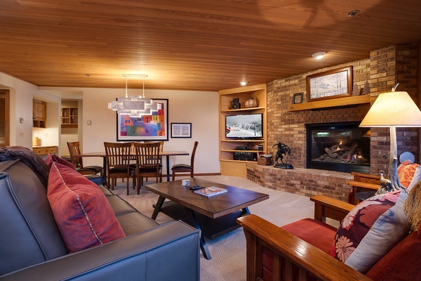 Unwind in your spacious living area with a crackling fireplace, cozy seating, and warm wood accents creating the perfect retreat after a day of adventure.