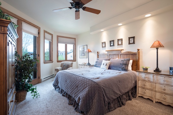 Your peaceful bedroom retreat features a plush king bed, warm wood furnishings, and soft lighting—perfect for unwinding after a day of adventure.
