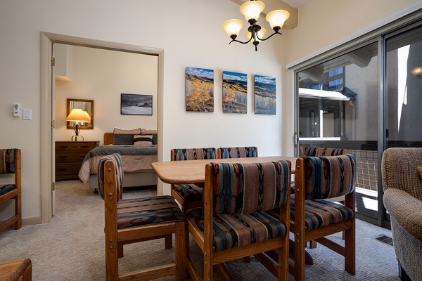 Gather for meals at your cozy dining table, perfectly positioned between the bedroom and private balcony for easy indoor-outdoor living.