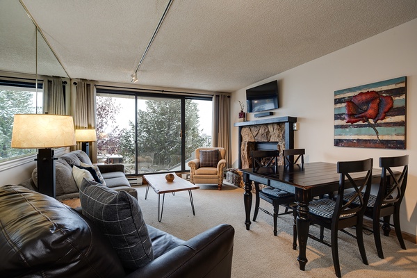 Gather in this inviting living space where your group can unwind after a day of adventure. Large windows frame mountain views, while the fireplace adds warmth on chilly evenings.