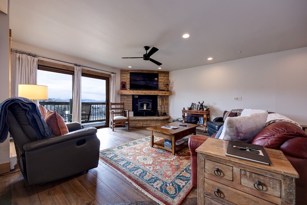 Unwind in your cozy living room, where plush seating, a warm fireplace, and sweeping mountain views create the perfect retreat after a day of adventure.