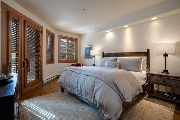 Slip into crisp, cloud-soft linens in this thoughtfully designed bedroom, where warm wood tones and tasteful lighting create a restful retreat for your stay.