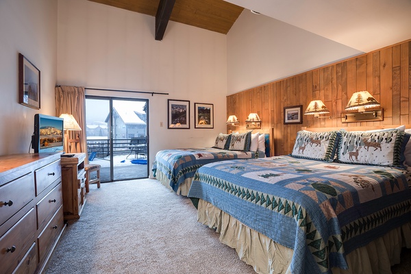 Slip into cozy beds with rustic warmth, vaulted ceilings, and mountain charm. Your balcony access opens to snowy serenity—perfect for a restful alpine escape.
