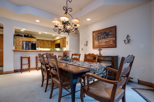 Gather around this inviting dining table for memorable meals together. The open-concept layout connects you to the fully-equipped kitchen, making hosting effortless and fun.