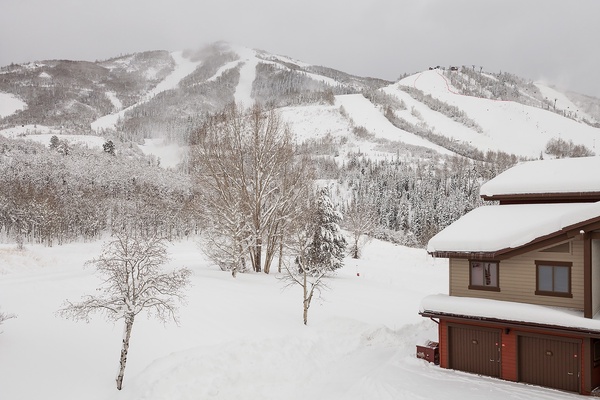 A mountain ski resort property nestled at the base of pristine slopes, offering direct access to winter adventures and stunning alpine scenery.