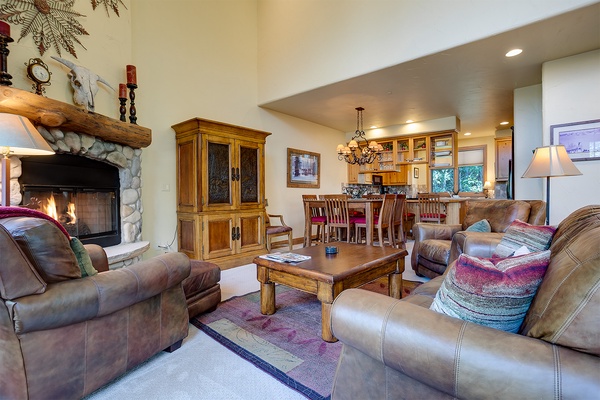 Sink into plush leather sofas by the stone fireplace, gather around the rustic coffee table, or chat at the open kitchen bar—your perfect home base for mountain memories.