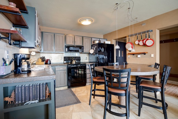 Your fully equipped kitchen awaits with gleaming appliances, granite counters, and a breakfast bar where you can share morning coffee or plan the day's adventures together.