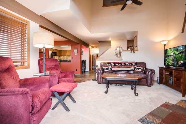 Settle into this spacious living room with vaulted ceilings, rustic beams, and plush seating. Unwind with your favorite shows on the large TV, or simply soak in the warm ambiance of your mountain retreat.