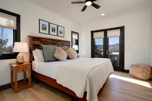 Sink into plush comfort and wake to mountain vistas through your private balcony doors. Warm wood tones and soft textures create your perfect mountain retreat.
