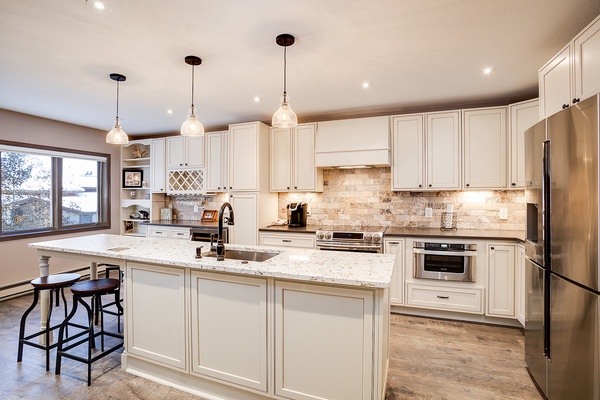 Your gourmet kitchen awaits with gleaming granite countertops, stainless steel appliances, and elegant pendant lighting. The spacious island invites you to gather for meals or plan your daily adventures in this thoughtfully designed space.