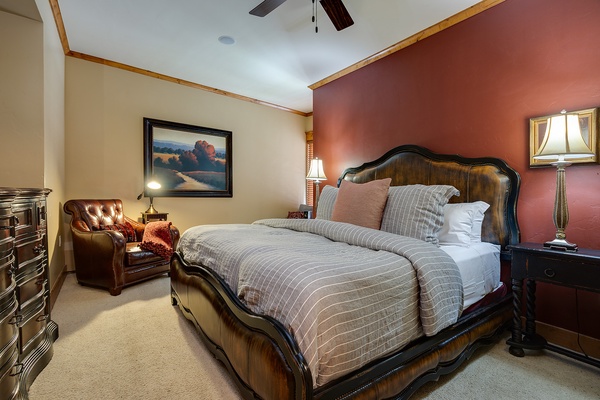 Sink into the plush bedding and unwind in this inviting bedroom, where warm tones and elegant furnishings create a restful retreat after your day's adventures.