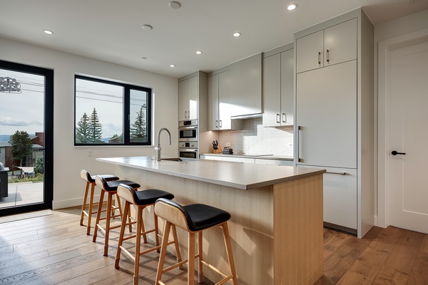 You'll love whipping up meals in this bright, modern kitchen with sleek countertops, ample storage, and a spacious island perfect for morning coffee or gathering with friends.