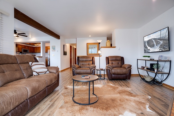 Sink into plush recliners and unwind in your spacious living room, where wood beams and mountain views remind you you're truly on vacation.