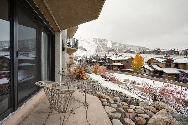 Sip your morning coffee on your private balcony and soak in stunning mountain views framed by autumn foliage and fresh snow—a peaceful escape with ski slopes just beyond the rooftops.