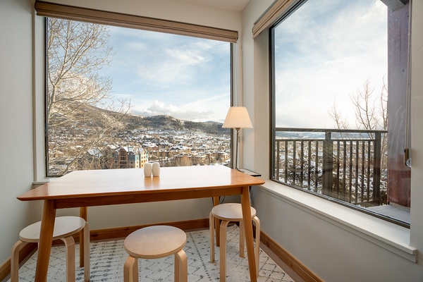 A quiet corner framed by sweeping mountain and town views—perfect for morning coffee or planning your next adventure in the snowy peaks beyond.