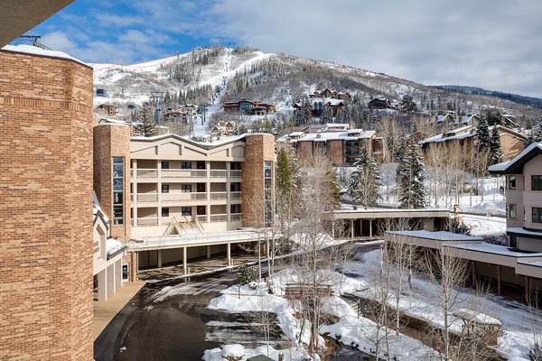 Stunning winter mountain views frame this ski resort property, surrounded by snow-dusted peaks and alpine slopes. A premier setting for your next mountain getaway.