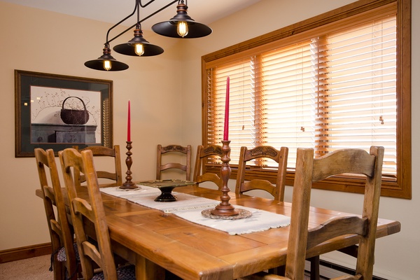 Gather around this inviting dining table, where warm wood tones and soft natural light create the perfect setting for your morning coffee or evening meals with loved ones.