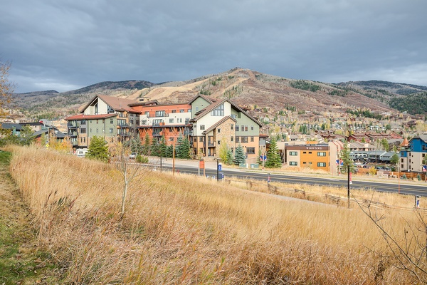 The property sits nestled in a mountain valley community, surrounded by dramatic peaks and seasonal foliage. A peaceful neighborhood setting with convenient access to local amenities.