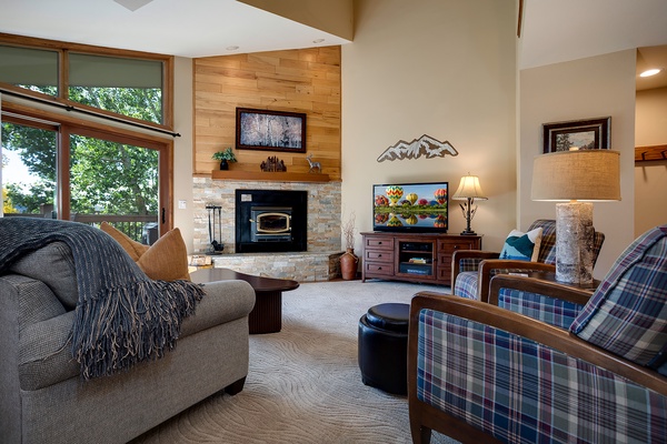 Sink into cozy seating by your private fireplace, where mountain views and rustic-modern design create the perfect retreat after a day of adventure.