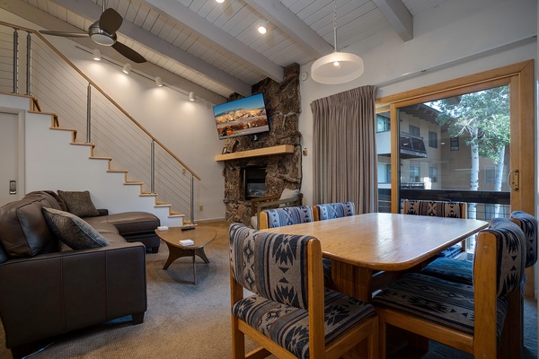 Relax in your open-concept living space with vaulted ceilings, a cozy stone fireplace, and easy access to your private balcony—perfect for unwinding after a day of adventure.