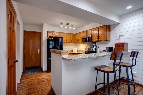 Your fully equipped kitchen awaits with granite countertops, stainless appliances, and a breakfast bar where you can sip morning coffee and plan your day.