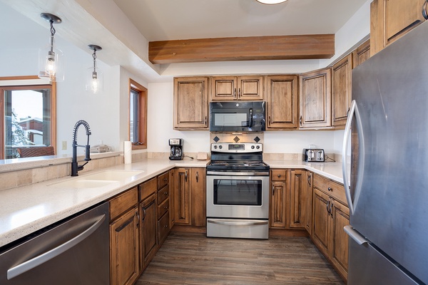 Your fully equipped kitchen invites effortless meal prep with modern stainless appliances, warm wood cabinetry, and ample counter space. Gather, cook, and create memories in this welcoming heart of your home.