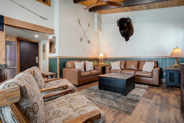 Unwind in your inviting living room where rustic charm meets comfort—perfect for gathering after a day of mountain adventures.