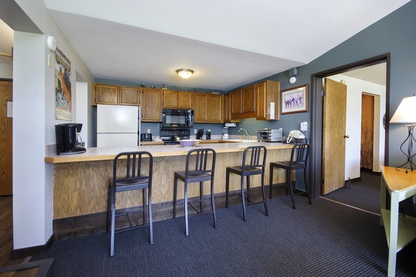 Step into your fully-equipped kitchen with breakfast bar seating, where you can whip up meals or sip morning coffee in comfortable style.