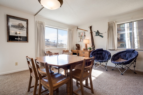 Relax in this sun-filled living and dining space, where your group can gather for meals, games, and conversations by the large windows overlooking the city.