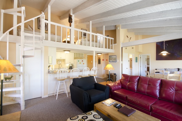 Step into your spacious open-plan retreat with soaring ceilings, a cozy loft, and a full kitchen—your perfect home base for unforgettable getaways.