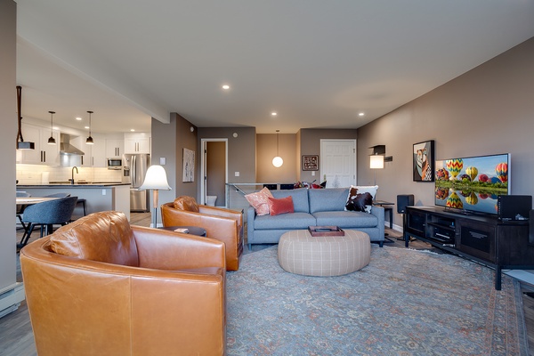 Sink into rich leather chairs and your plush sofa as you unwind with shows on the big screen. The open kitchen invites easy meal prep while you stay connected to the cozy living space.