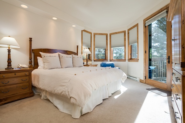 Sink into plush bedding and wake to mountain views through your private balcony door. Natural light fills your peaceful retreat with warm wood accents and everything you need to unwind.