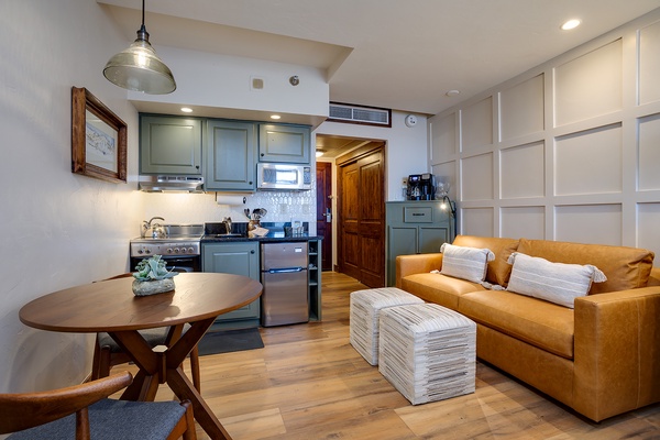 Settle into your cozy open-plan retreat with a vibrant mustard sofa, fully equipped kitchen, and warm wood tones that create the perfect home away from home.