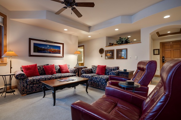 Sink into plush seating and unwind in your thoughtfully designed living room, where rich leather recliners and cozy sofas invite you to relax after a day of mountain adventures.
