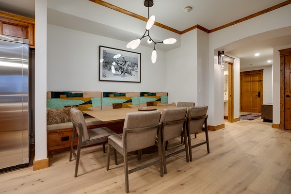 Gather your group around this spacious dining table with built-in banquette seating, perfect for shared meals and conversation in your mountain retreat.