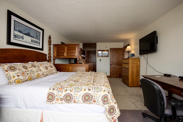 Settle into your cozy retreat with a beautifully dressed bed, warm wood furnishings, and all the comforts of home—including a flat-screen TV and dedicated workspace for your mountain getaway.