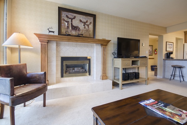 Gather by your private fireplace for cozy evenings, enjoying the warm glow and mountain-inspired decor that makes this living room feel like home.