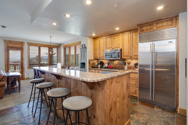 Your fully-equipped kitchen invites easy meal prep, with granite countertops, stainless steel appliances, and a spacious island for gathering over morning coffee or evening appetizers.