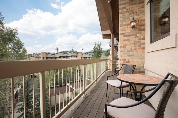 This view overlooks a residential neighborhood with nearby buildings and hillside greenery, offering context for the property's setting and surrounding area.