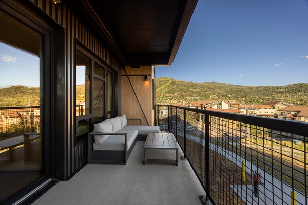 Step onto your private balcony and soak in stunning mountain views—your perfect spot for morning coffee or unwinding as the sun sets over the hillside town below.