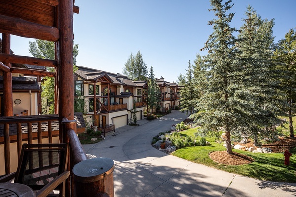 Mountain resort community featuring contemporary alpine architecture, mature evergreen trees, landscaped grounds, and a peaceful residential setting with multi-level homes and private access roads.