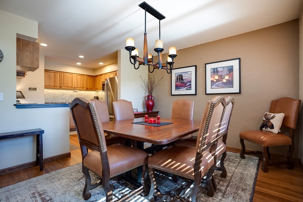 Gather around this inviting dining space where sunlight streams through, creating a warm ambiance for your meals. The open kitchen layout makes entertaining effortless and enjoyable.
