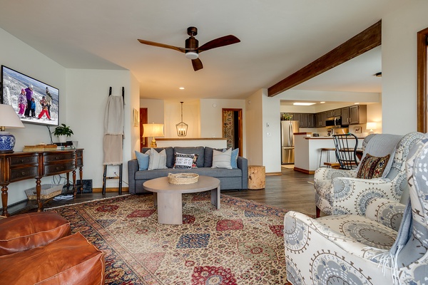 Unwind in this welcoming living space with cozy seating, ceiling fan, and open flow to your fully-equipped kitchen—perfect for relaxing evenings together.