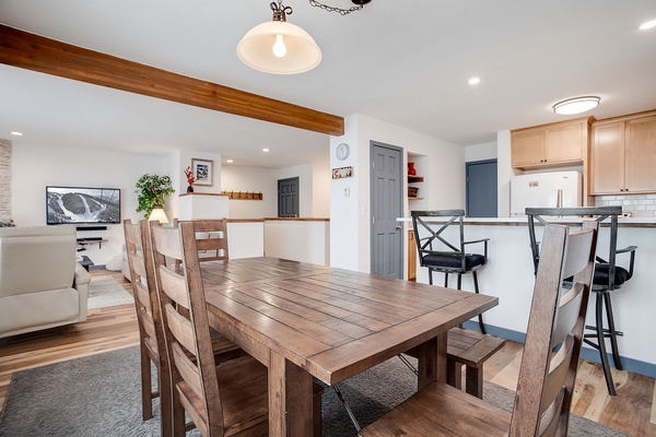 Gather around this beautiful rustic dining table with your travel companions, where warm wood tones and open-concept design create the perfect space for sharing meals and making memories together.