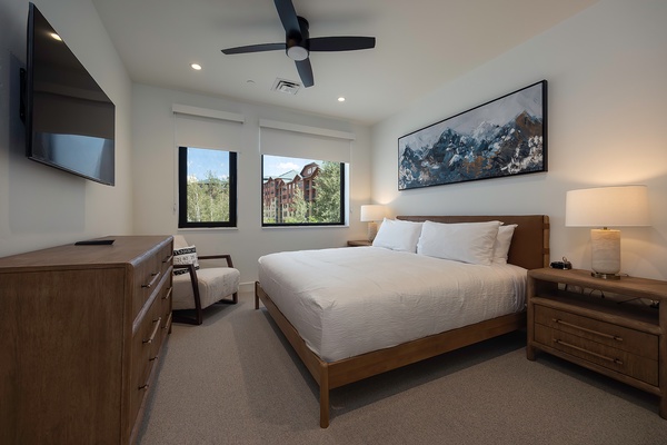 Sink into crisp linens and wake up to sunshine streaming through your windows. Your plush bed invites restful sleep, while modern wood furnishings and a ceiling fan ensure comfort throughout your stay.