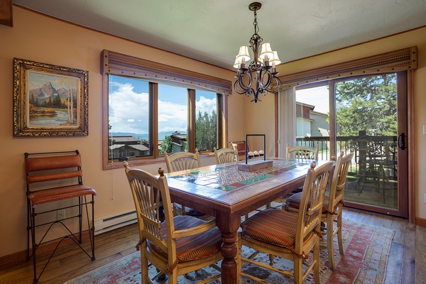 Gather around a warm dining space where lake views and mountain scenery frame your meals. Large windows invite natural light while you enjoy cozy conversations and mountain living at its finest.