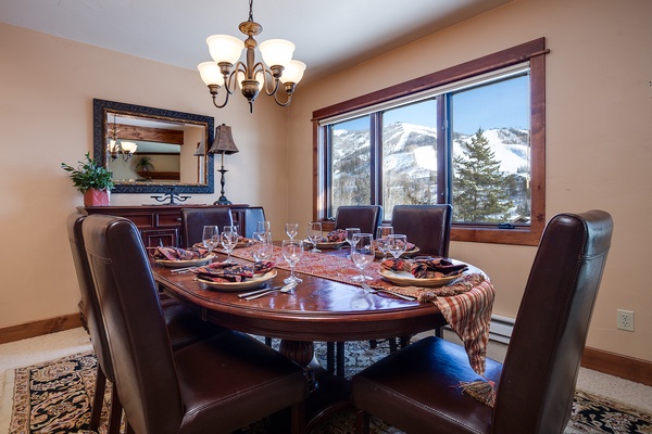 Gather around the elegant dining table where mountain vistas frame every meal, creating unforgettable moments with those you love most.