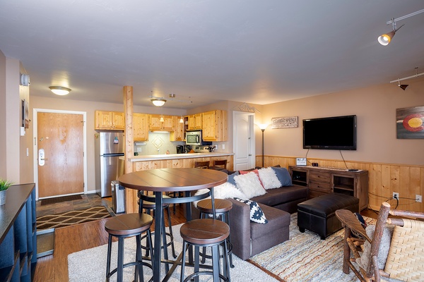 Step into this inviting open-concept space where the kitchen flows seamlessly into your living and dining areas. Warm wood tones and modern touches create a cozy mountain retreat vibe perfect for relaxing after a day of adventure.