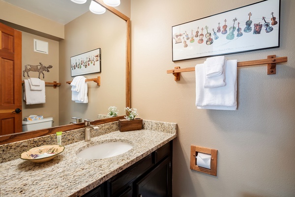 Step into your own private oasis with a spacious granite vanity, artistic touches, and fresh white linens waiting to welcome you after a day of adventure.